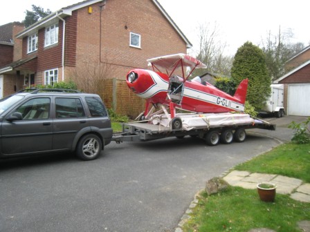 Great Lakes on trailer to hangar